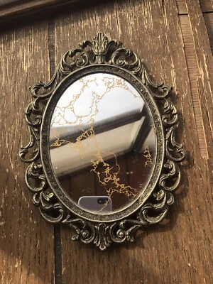 Espejo Estilo Regencia Ovalado Años 60 Mármol Decorativo Dorado Ahumado con Marco de Metal Foto 1 de 4