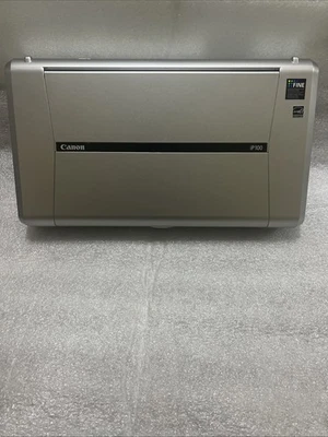 Pre-owned CANON IP100 INKJET PRINTER W/ MANUAL, DISK, POWER CORD And Extra Ink - Image 1 of 4