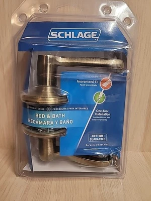 Palanca de puerta Schlage F40 V FLA 609 Flair, cerradura de privacidad para cama y baño, latón antiguo Foto 1 de 4