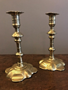 Pair of antique brass petal-base candlesticks, c. 1750 to 1755, c. 8 inches tall