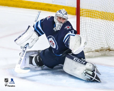 Connor Hellebuyck Winnipeg Jets Unsigned Blue Jersey Glove Save 8" x 10" Photo Cover