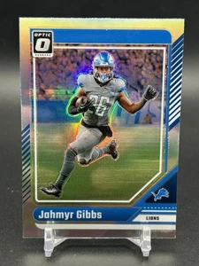 2024 Panini Donruss Optic - Jahmyr Gibbs #64 Holo Prizm - Picture 1 of 2