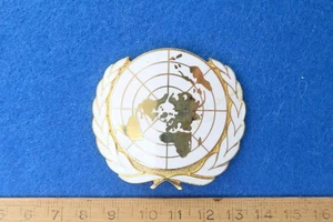 Insignia de gorra esmaltada oficial de las Naciones Unidas servicio militar del ejército - Imagen 1 de 2