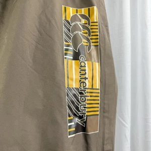 Canterbury Uglies Track pants Men's Size 4 XL Brown Yellow Logo Mens Women’s Uni - Foto 1 di 5