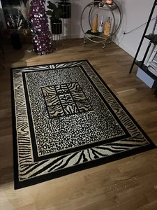 Teppich 130 cm x 190 cm Leopardenmuster Bordüre Schwarz Beige Braun - Bild 1 von 3