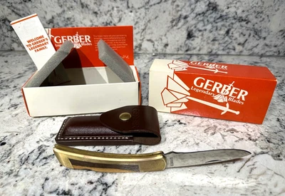 Cuchillo deportivo plegable de colección Gerber IId insertos de latón/madera EE. UU. 1980 IOB Foto 1 de 4