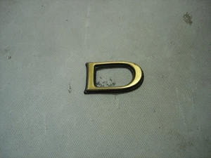 1998-2002 CADILLAC ELDORADO GOLD LOWER DOOR TRIM MOLDING SCRIPT LETTER "D" - Picture 1 of 3