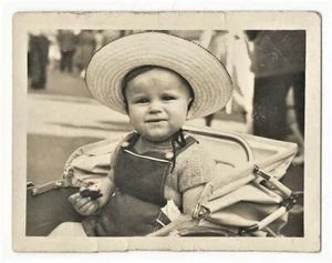 A MOST ADORABLE YOUNG CHILD SITTING IN A BABY CARRIAGE - Picture 1 of 2