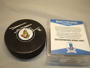 Disco de hockey Beckett autografiado por Dion Phaneuf firmado por senadores de Ottawa BAJO CERTIFICADO DE AUTENTICIDAD 1B - Imagen 1 de 3