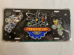DISNEY'S WDW TOMORROWLAND METAL LICENSE PLATE - SEALED IN PLASTIC - NEW - Picture 1 of 2