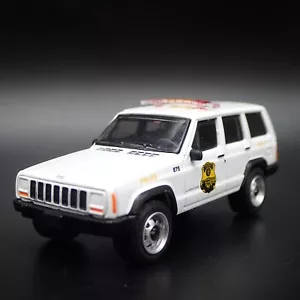 JEEP CHEROKEE XJ SPORT USA SECRET SERVICE POLICE 1:64 SCALE DIECAST MODEL CAR - Picture 1 of 7