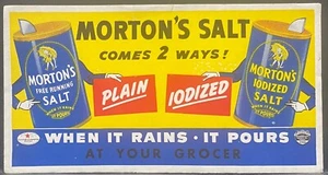 BORRADOR DE TINTA PUBLICITARIO DE SAL DE MORTON~DOS CAJAS DE MORTON CON MANOS HUMANAS - Imagen 1 de 2