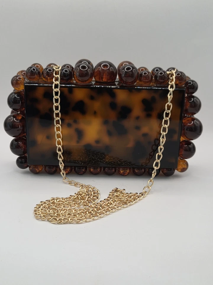 Cartera clutch Yendi leopardo tortuga acrílico Foto 1 de 4