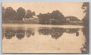 Rural Lakeside Scene with Houses & Trees Reflected in Water with Lily Pads RPPC - Picture 1 of 2