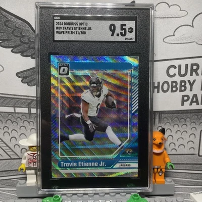 2024 Donruss Optic #89 Travis Etienne Jr. Wave Prizm /300 SGC 9.5 - Image 1 of 4