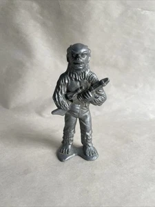 VINTAGE SILVER PLASTIC FIGURINE HOLDING A GUN - Picture 1 of 1