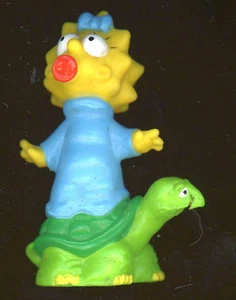Maggie Simpson 2 5/8" H Reitet auf einer Schildkröte saugt ihren Schnuller in USA B6-B6 - Bild 1 von 2