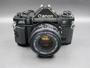 Cámara fotográfica vintage Canon A-1 SLR 35 mm negra + lente FD 50 mm F/1,8 ((LEER)) - Imagen 1 de 16