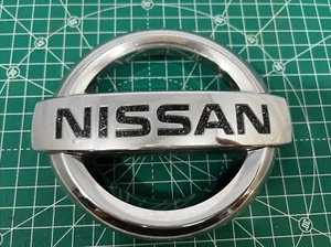 Used Nissan Xterra Pathfinder Frontier Front Grille Emblem Chrome 62890 EA000 U8 - Picture 1 of 8