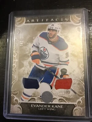 2024-25 ARTEFATOS DECK SUPERIOR EVANDER KANE MATERIAIS DOURADOS CAMISAS DUPLAS 143/299 - Imagem 1 de 2