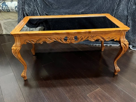 French style cocktail table with polished glass insert and hand-carved wood Cover