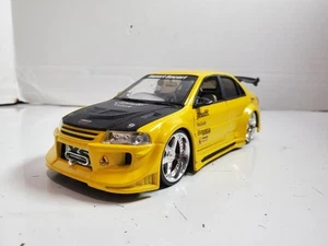 Imperfecto - Jada Toys Import Racer Mitsubishi Lancer Evolution VI Amarillo 1:24 - Imagen 1 de 13