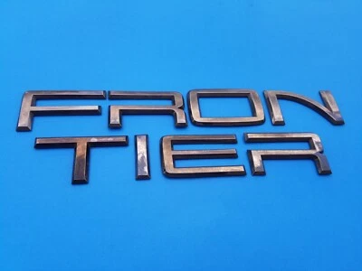 01 02 03 04 NISSAN FRONTIER PUERTA TRASERA EMBLEMA LOGOTIPO INSIGNIA SÍMBOLO OEM (2003) Foto 1 de 4