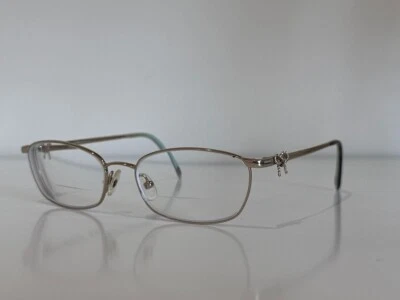 Marco cuadrado de gafas con lazo dorado pálido Tiffany & Co. TF 1099 6091 50-16-140 Foto 1 de 4