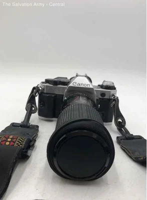 Canon AE-1 Silver Black 35mm Film Programmable SLR Camera With Strap - Image 1 of 4