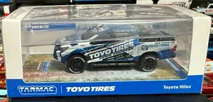 Tarmac Works 1:64 Toyota Hilux Toyo Reifen blau weiß - Bild 1 von 1