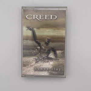 Cassette de arcilla humana Creed 1999 de colección con brazos abiertos cuerda usado - Imagen 1 de 5
