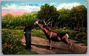 Postcard Grayling MI c1940s Greetings from Grayling Michigan Man Kissing a Deer - Photo 1/2