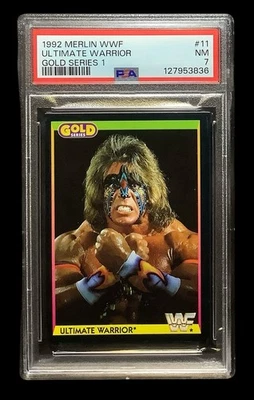 1992 merlin wwf #11 ultimate warrior rc; gold series 1 wrestling PSA 7 (RARE) - Image 1 of 2
