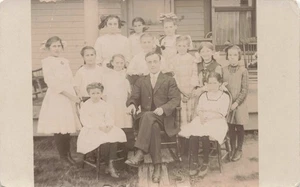 1908-1915 Piano Teacher Surrounded by his 12 Young Girl Students RPPC Postcard - Picture 1 of 2