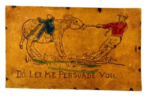 Cartolina antica in PELLE LASCIA CHE TI CONVINCA uomo che tira asino testardo - Foto 1 di 2
