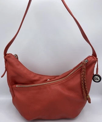 Bolso de mano The Sak de cuero naranja para mujer con una correa en dos direcciones con borlas y cremallera Foto 1 de 4