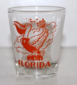 Gaviota naranja Shot Glass FLORIDA sosteniendo una copa de champán burbujeante - Imagen 1 de 3