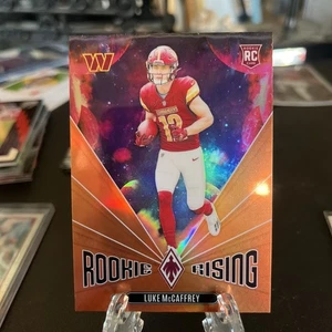2024 Panini Phoenix - Rookie Rising Luke McCaffrey #RR-LMC Orange (RC) - Picture 1 of 2