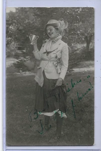 Real Photo Postcard RPPC - Woman in Comical Costume Holding Small Trophy - Picture 1 of 2