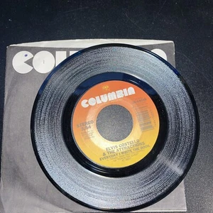 ELVIS COSTELLO & THE ATTRACTIONS EVERYDAY I WRITE THE BOOK / HEATHEN TOWN 45 RPM - Foto 1 di 2