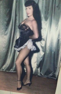 A 16 X 23 POSTER OF BETTY PAGE AS A MAID - Image 1 of 2