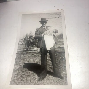 Man all dressed up holding baby all dressed up - Picture 1 of 3