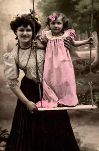PRETTY YOUNG MOTHER:& HER ADORABLE CHILD STANDING ON A SWING :FRANCE : 1919 RPPC - Picture 1 of 3