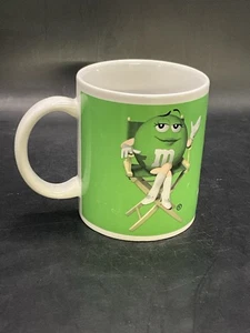 M&M Green Coffee Mug Mars Tea Cup 80’s Directors Chair Candy Icon - Picture 1 of 6