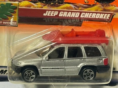 Matchbox #65 Jeep Grand Cherokee, Silver w/ Raft, 1/64, NIB - Image 1 of 2