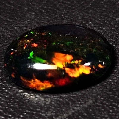 NATURAL AAA+FULLFIRE COLOR PLAY OVAL CABOCHAN  ETHIOPIAN WELO BLACK OPAL 1.00CTS - Image 1 of 3