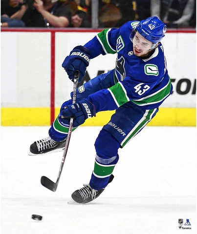 Quinn Hughes Vancouver Canucks Unsigned Blue Jersey Passing Photograph Cover
