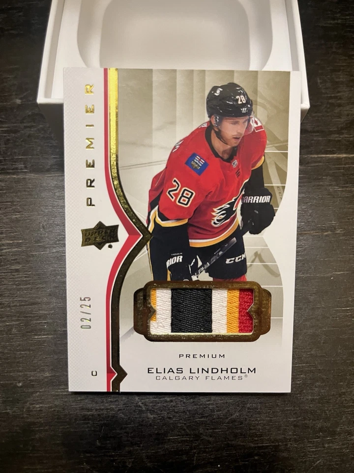 2020-21 UD PREMIER PATCH BASE PARALLEL 2/25 ELIAS LINDHOLM #18 CALGARY FLAMES - Image 1 of 2