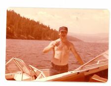Shirtless hairy chest man on boat drinking beer  Vintage snapshot color  photo