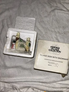 DEPT 56 HERITAGE VILLAGE ACCESSORY - VILLAGE SIGN WITH SNOWMAN - Picture 1 of 1